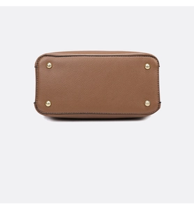 Detail of brown litchi pattern leather tote base with four gold metal protective feet