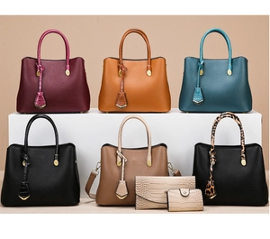 Detailed arrangement of multiple leather tote bags and matching wallets in various colors