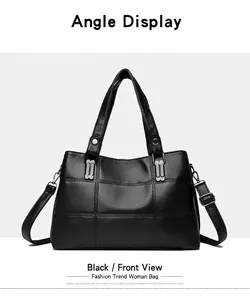 Detail of black pebbled PU leather tote bag with quilted stitching and diamond buckle