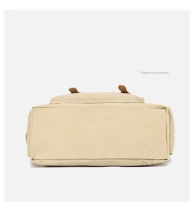 Detail view of the reinforced rectangular base on this vintage beige canvas travel bag