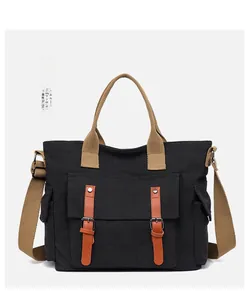 Detailed close-up of retro black canvas travel bag with orange leather buckle accents