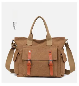 Detail of khaki canvas bag showing leather buckle pockets and adjustable shoulder strap