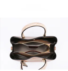Internal view of brown tote bag showing multi-compartment structure and striped lining