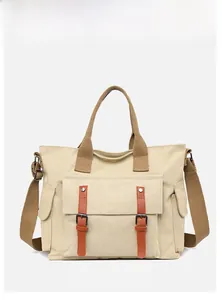 Close-up of canvas tote bag showing front flap pocket with leather buckles and side pouch