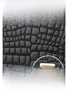Detail of black crocodile texture leather bag with elegant golden square metal lock buckle