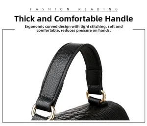 Detail of black crocodile texture handbag with golden metal rings and fine stitching