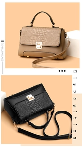 Detail of elegant handbag with crocodile texture flap and metal twist lock closure