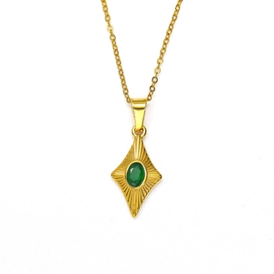 Elegant gold chain necklace with a vintage green gemstone rhombus pendant and radiant carvings