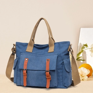 Blue canvas crossbody tote bag with brown leather straps and multi-pocket vintage design