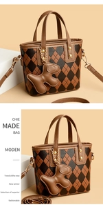 Detail of vintage rhombic pattern crossbody bucket bag with a cute bear charm