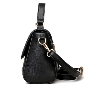 Elegant black pebbled leather handbag with gold hardware and removable shoulder strap