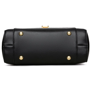 Bottom view of black pebble leather handbag with gold metal feet and fine stitching details