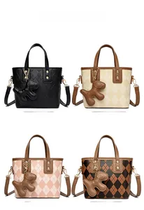 Four stylish PU leather bucket bags in black, apricot, pink, and brown with puppy charms