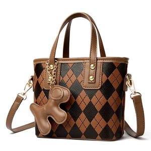 Chic brown and black argyle pattern bucket bag with golden hardware and dog charm