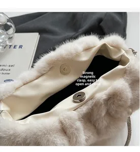Detail of plush handbag with magnetic buckle closure and faux leather lining