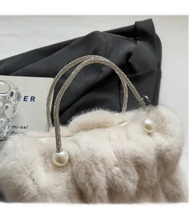 Detail of plush cloud bag with dual rhinestone chains and decorative pearl accents