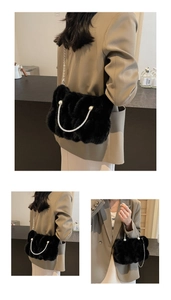 Close-up of black faux fur bag with silver chain, pearls and sparkling rhinestone details