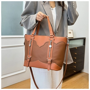 Detailed view of vintage color-blocked tote bag with long zippers worn by model