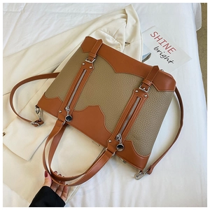 Detailed macro view of retro color-block tote bag showing stitching and silver zippers