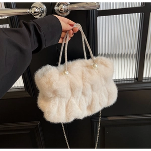 Detailed shot of furry faux fur handbag with rhinestone handle and pearl accents