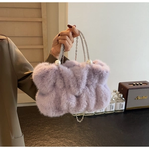 Detail of lavender faux fur handbag with rhinestone handle, pearls and silver chain