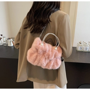 Pink faux fur handbag with pearl details and a rhinestone-encrusted metal handle