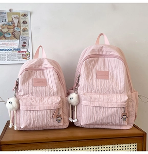 Detailed close-up of pink school backpacks with bubble texture and cute plush charms