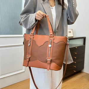 Brown leather patchwork tote bag with silver zippers and stylish shoulder strap