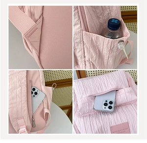 Detail view of pink bubble grid backpack featuring side water bottle pocket and back zipper pocket