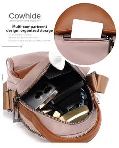 Detail of multi-compartment leather crossbody bag showing internal storage for phone and cards