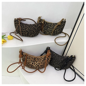 Detailed display of four leopard print crossbody crescent bags in various trendy colors
