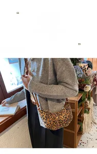 Detail of leopard print half-moon crossbody bag with slim strap on a model