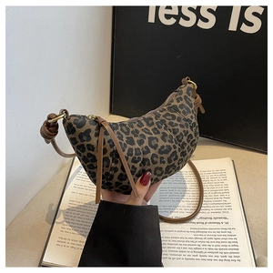 Detail of leopard print crescent bag with brown strap and retro matte finish