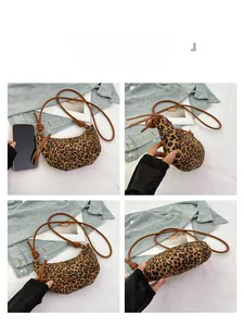 Detail view of leopard print crescent crossbody bag with knotted strap and size comparison