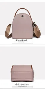 Detail view of pink crossbody bag showing the rear headphone port and bottom structure