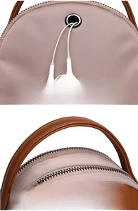 Detail of pink crossbody bag with reinforced headphone port and leather top handle