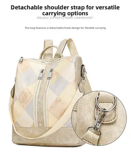 Detail view of detachable shoulder strap with golden metal hook on geometric PU backpack
