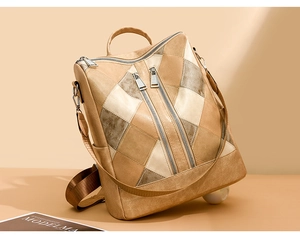 Detail of beige and tan geometric stitching on a vintage PU leather backpack with zippers
