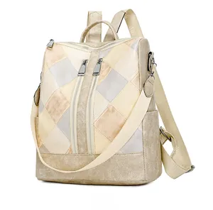 Detail of geometric quilted faux leather backpack with detachable shoulder strap and zippers