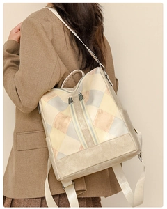 Detail view of stylish quilted faux leather backpack with geometric colorblock pattern
