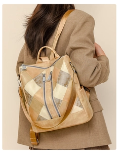 Detail view of khaki patchwork PU leather backpack with anti-theft back zipper on model