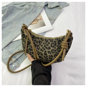 Detailed shot of leopard print crescent bag with brown knotted strap and gold zipper