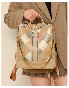 Detail of multi-color patchwork backpack with vertical zippers and soft PU leather texture