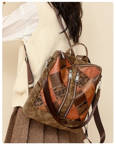 Close-up of vintage multi-color patchwork backpack with brown straps and zipper detail