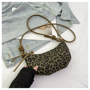 Detail of vintage leopard print hobo bag with knotted brown leather strap on white fabric