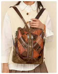 Detail of vintage patchwork faux leather backpack with brown earthy tones and metallic zippers