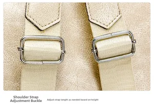 Detail view of adjustable fabric shoulder straps with metal buckles on a PU leather backpack