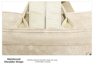 Close-up of reinforced shoulder straps on a beige leather backpack with diamond stitching