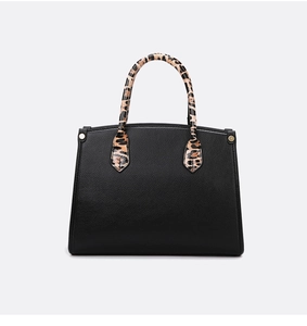 Close-up of black lychee grain leather tote bag with leopard print round handles