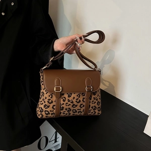 Minimalist leopard print crossbody bag with gold buckles and adjustable shoulder strap